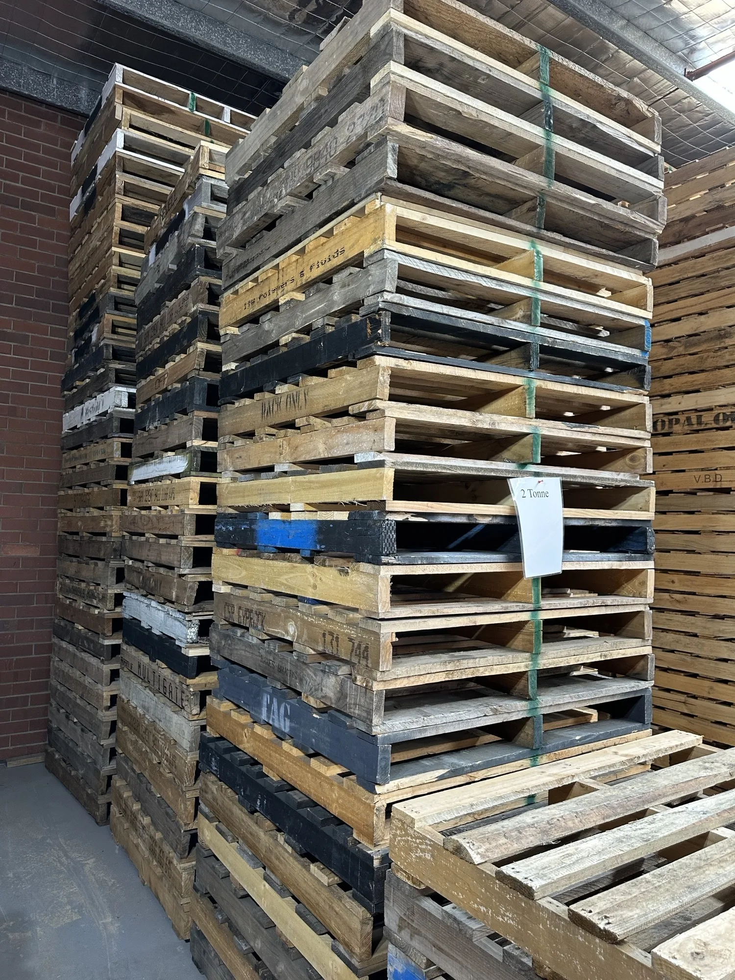 Branded timber pallets stacked at the yard