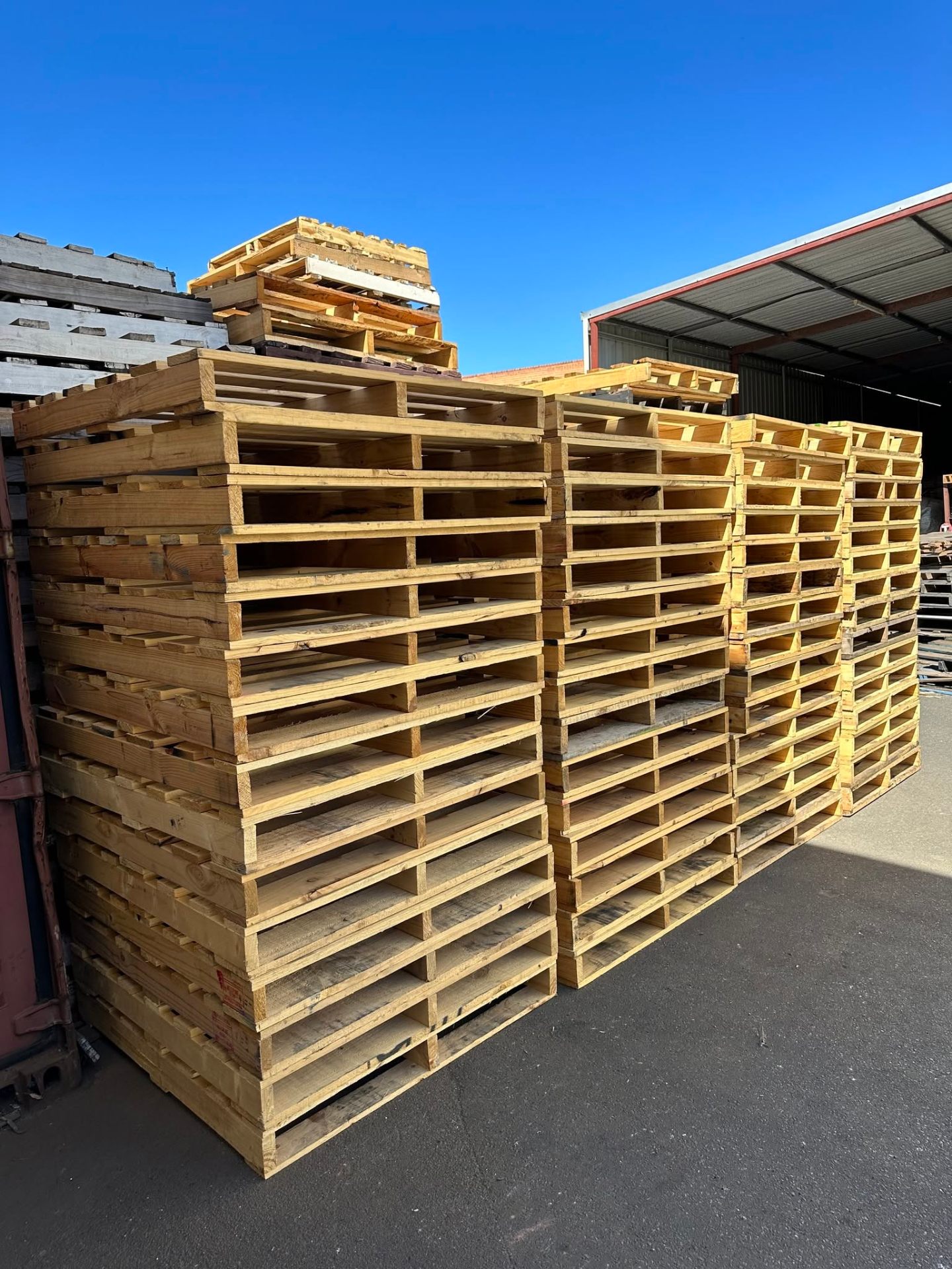 Tall stacks of repaired Australian standard pallets at the Wangara yard